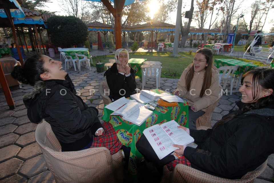 Muslim young women study their lessons in cafe